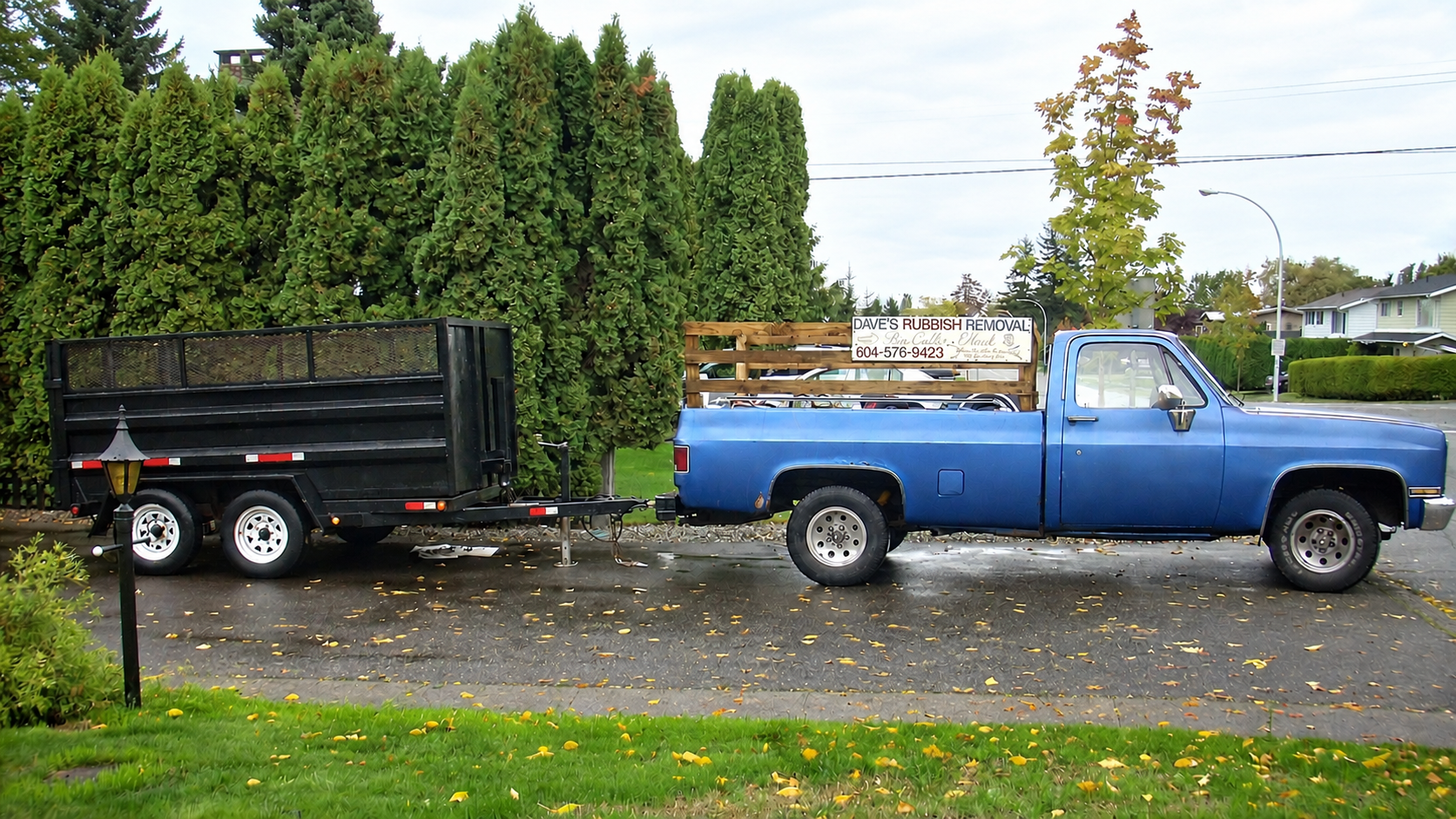 Dave's Rubbish Removal blue pickup and black trailer in Surrey, BC